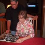 Larry and Leah Jones (Overland Park, KS) enjoy the '68 yearbook at the Friday night dinner/social at the Bartelsmeyer home.