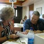 Joyce Peel Metcalf and Rick Hite visit at registration